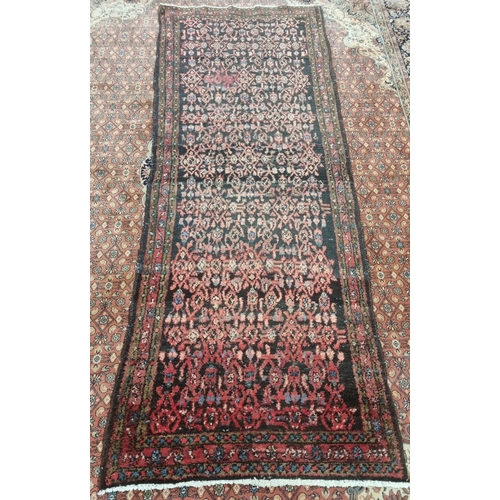 1000 - A deep ground Iranian Runner with a bust all over design, 283 x 110 cm approx.