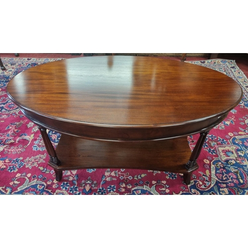 845 - A Mahogany oval coffee Table with pillared supports. H 48 x 60 x 60 cm approx.