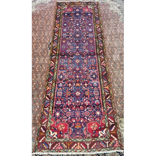 852 - A multicoloured ground Persian Hamadan Runner with an all over central medallion design, 330 x 102 c... 