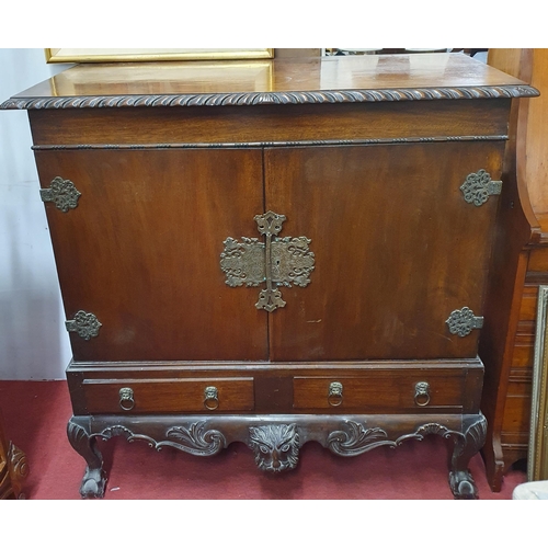 506 - A late 19th early 20th Century Walnut two door Silver Cabinet possibly Irish on carved cabriole fron... 