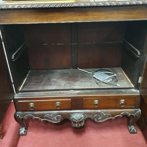 506 - A late 19th early 20th Century Walnut two door Silver Cabinet possibly Irish on carved cabriole fron... 