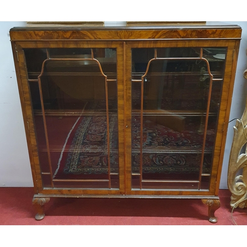 527 - An early 20th Century Walnut and Veneered two door glazed Display Cabinet on carved cabriole support... 