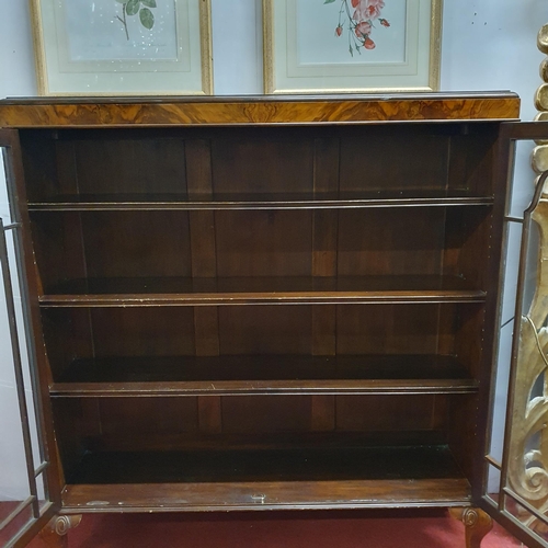 527 - An early 20th Century Walnut and Veneered two door glazed Display Cabinet on carved cabriole support... 