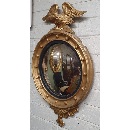 805 - A 19th Century Timber and Plaster Gilt Convex Mirror with eagle surmount.
H 90 x 55 cm approx.