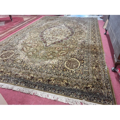 1002 - A large green and cream ground Carpet with multi borders and unique medallion design. 488 x 300 cm a... 