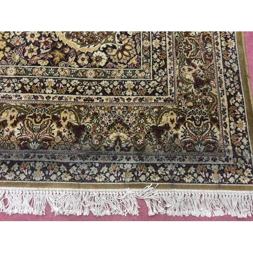 1002 - A large green and cream ground Carpet with multi borders and unique medallion design. 488 x 300 cm a... 