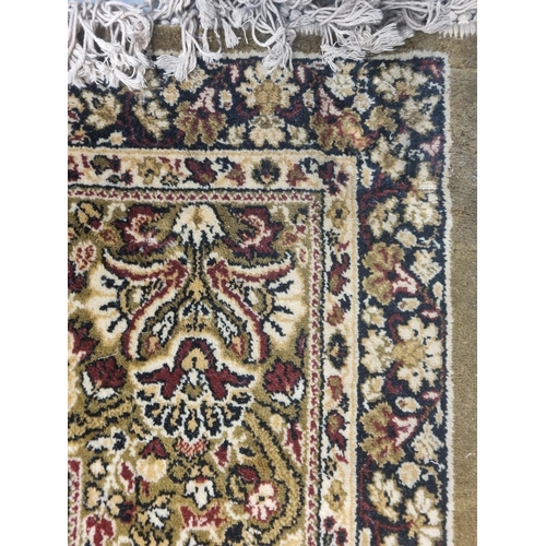 1002 - A large green and cream ground Carpet with multi borders and unique medallion design. 488 x 300 cm a... 