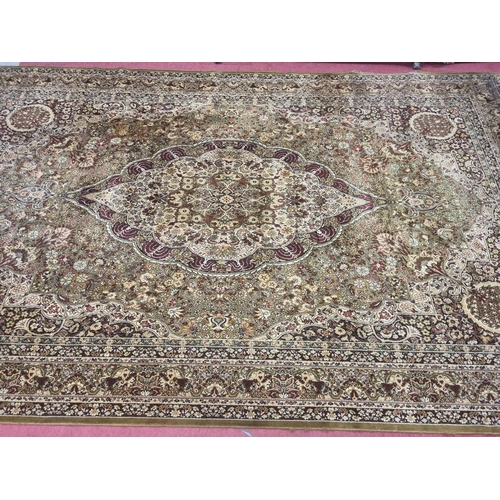 1002 - A large green and cream ground Carpet with multi borders and unique medallion design. 488 x 300 cm a... 