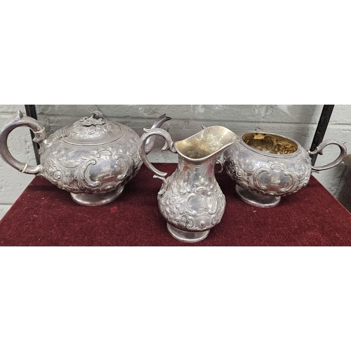 379 - An Irish Silver three piece Tea set, John Smith 1864, with a highly embossed outline, 1425 gms