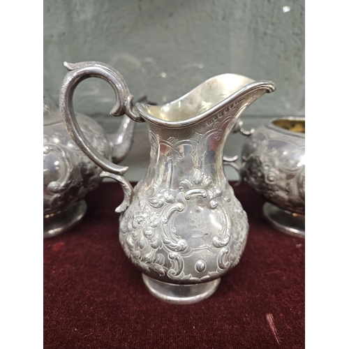 379 - An Irish Silver three piece Tea set, John Smith 1864, with a highly embossed outline, 1425 gms