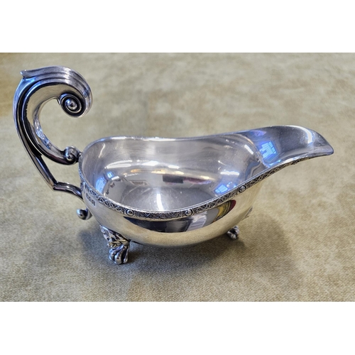 384 - An Irish Silver sauce Boat, J.M & Co with lions head and paw feet and Celtic banded top. 113 gms app... 