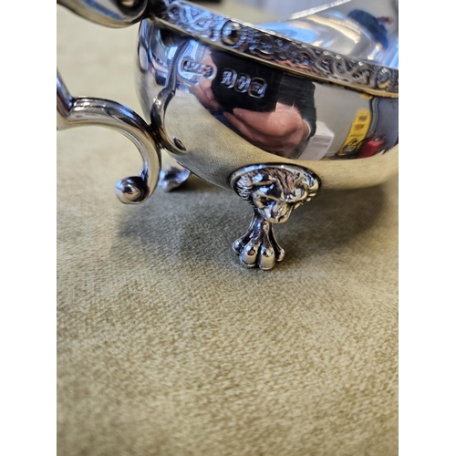 384 - An Irish Silver sauce Boat, J.M & Co with lions head and paw feet and Celtic banded top. 113 gms app... 