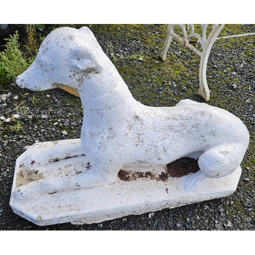 1025 - A recumbent stone Greyhound. 
H 46 x L 67 cm approx.