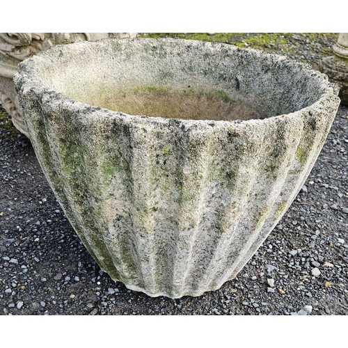 1027 - A Stone Pot with ribbed outline. H 35 x D 47 cm approx.