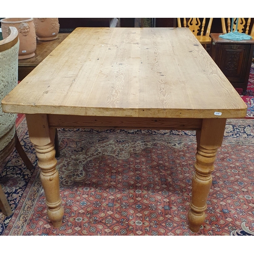 879 - A good stripped and waxed Pine Kitchen Table of neat size on turned supports. H 78 x 152 x 90 cm app... 