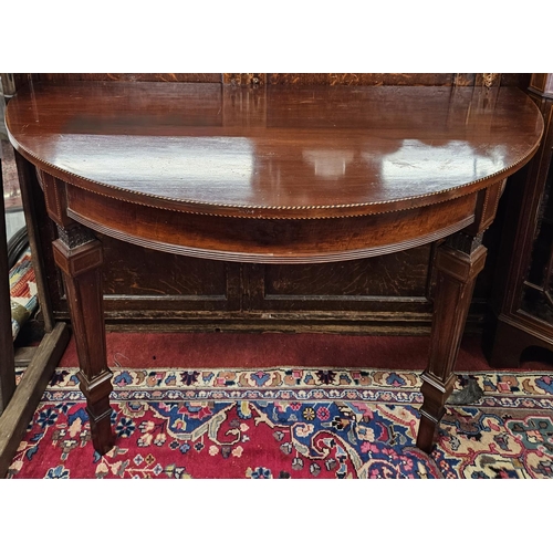 900A - A good pair of 19th Century wall mounted half moon Tables with inlaid edge and tapered supports. .