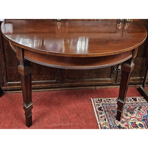 900A - A good pair of 19th Century wall mounted half moon Tables with inlaid edge and tapered supports. .