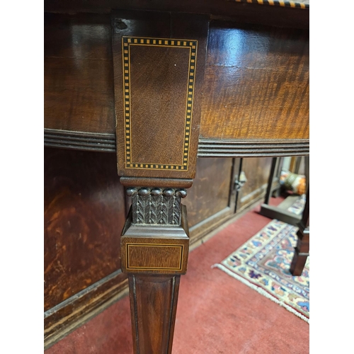 900A - A good pair of 19th Century wall mounted half moon Tables with inlaid edge and tapered supports. .