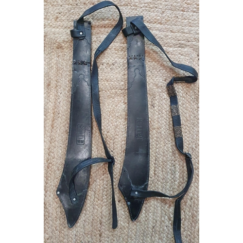 22 - A Good pair of heavy leather Scabbards .
L 76 cm approx.
