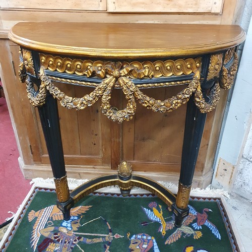 80 - A highly moulded ebonised and gilded half moon console Table. 
Height 80 x W 82 x D 37 cm approx.