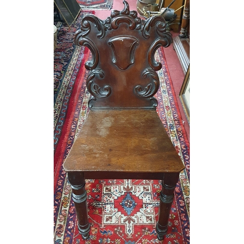 202 - An early to mid 19th Century Mahogany Hall Chair with armorial panel back. W 40 x SH 44 x BH 84 cm a... 