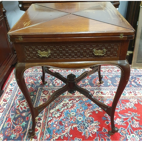 222 - An Edwardian Mahogany Envelope Card Table with pierced frieze outline on cabriole supports with stre... 