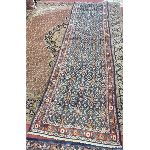 247 - A large and long deep Blue ground Persian Sarouk Runner with an all over pattern design. 410 x 141cm... 