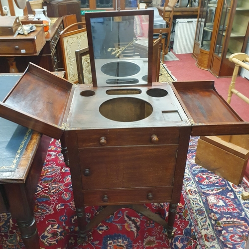 482 - An early 19th Century Mahogany gentleman's Washstand on turned supports, stretcher base and brass ca... 