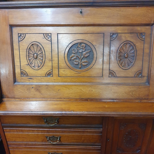 503 - An early 20th Century Art Nouveau craft style Bureau with flap front over a bank of drawers and gall... 