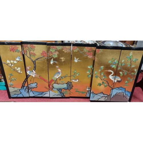 577 - A very fine six panel Chinese polychrome Screen with gold lacquered and embossed decoration with exo... 