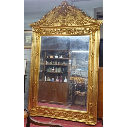 589 - An extremely large Plaster and Gilt Overmantel Mirror with lions head top bevelled edge glass and hi... 