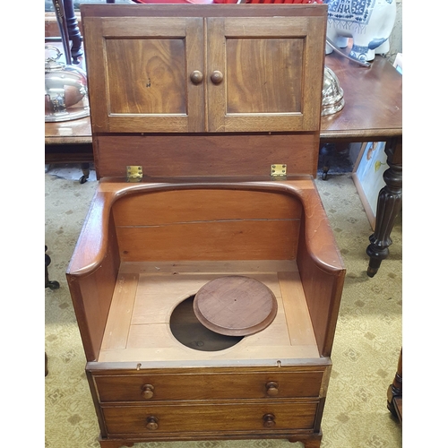 615 - A Georgian Mahogany Chest Commode with a plain rectangular hinged top above pair of faux panel doors... 