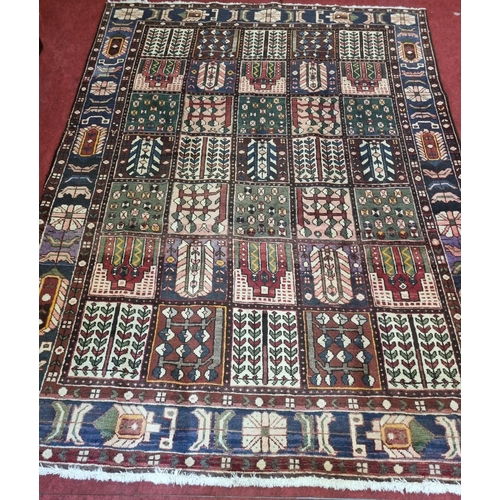 959 - A multi ground Persian Carpet with a traditional panel garden design, 293 x 203 cm approx.