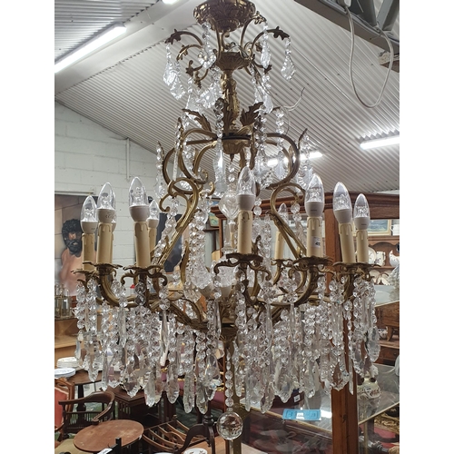 591 - A Magnificent eight branch Brass and Crystal Chandelier profusely decorated with drop crystals. W 65... 