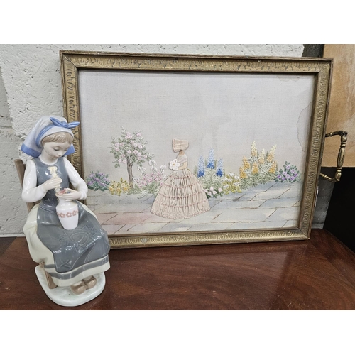 101 - A Lladro Figure of a girl with a vase of flowers along with a needlework tray. H 23 cm approx.