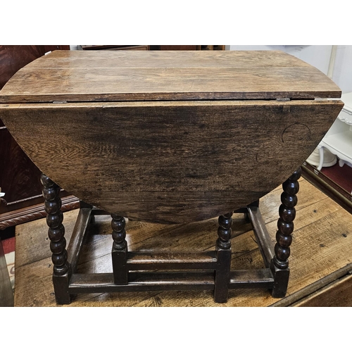 490 - An 18th possibly early 19th Century provincial Oak Gateleg Table of simple form with turned bobbin s... 