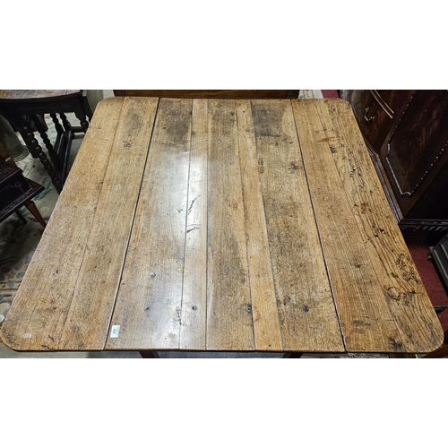 494 - An 18th Century Oak and Elm provincial dropleaf Kitchen Table with drawered frieze on square support... 