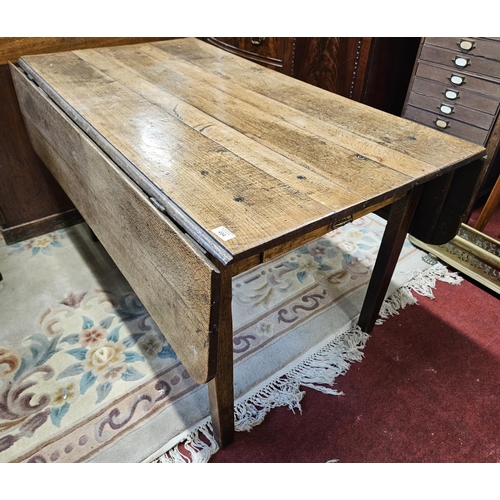 494 - An 18th Century Oak and Elm provincial dropleaf Kitchen Table with drawered frieze on square support... 