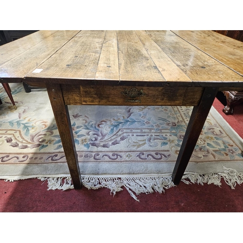 494 - An 18th Century Oak and Elm provincial dropleaf Kitchen Table with drawered frieze on square support... 