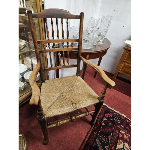 595 - An early 19th Century Elm provincial Armchair with turned ribbed back on simple pad supports and str... 