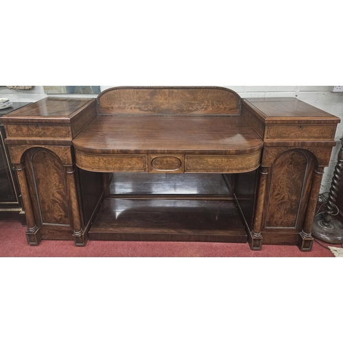 86 - An early 19th Century Mahogany Irish pedestal Sideboard with panel flame grain doors with turned col... 