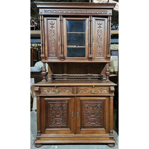 1120 - A Large Continental Walnut Cabinet, with carved wood detail and chequered top. H 230 x 132 x 58 cm a... 