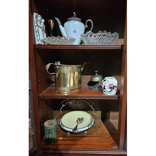 1135 - A group of decorative Items on three shelves .