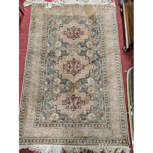 451 - A cream ground Rug with multi borders and repeating medallion design. 178 x 118cm approx.