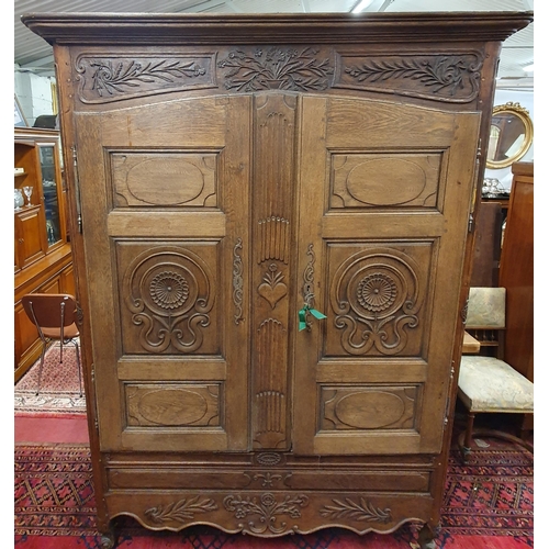 531 - A Magnificent 19th Century Oak Armoire with highly carved outline, panelled doors and fluted outline... 