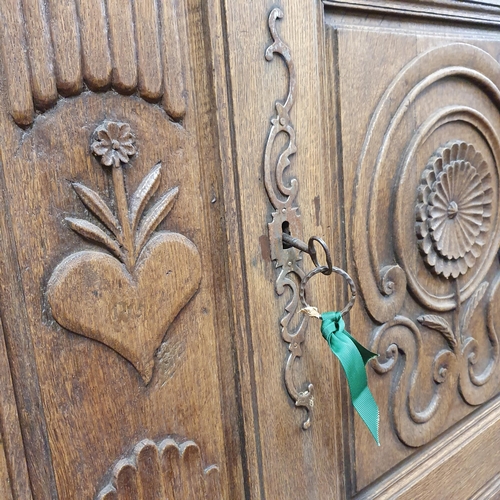 531 - A Magnificent 19th Century Oak Armoire with highly carved outline, panelled doors and fluted outline... 