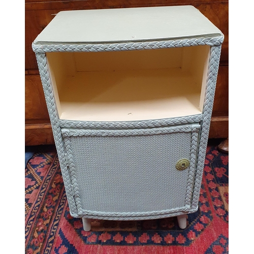 537A - A blue Lloyd Loom Bedside Cabinet with single door front along with a pink linen bin.