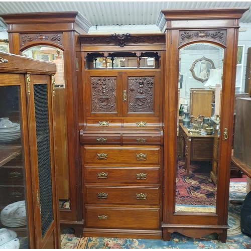 542 - A Superb 19th Century Walnut two door Wardrobe with highly carved centre flanked by twin bevelled mi... 