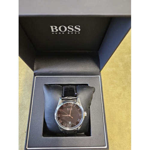 426 - A good Hugo Boss mans wrist Watch with a Black and Steel face, seems to be keeping good time.