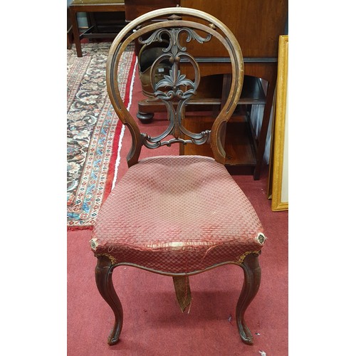 611 - A 19th Century Mahogany single Dining Chair with sabre leg and highly carved back along with a late ... 